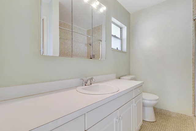 bathroom with tile patterned floors, walk in shower, vanity, and toilet