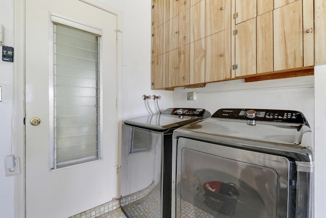 laundry room featuring cabinets and washer and dryer