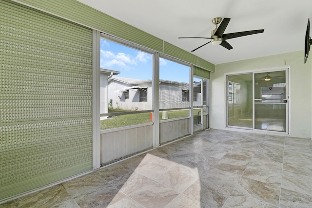 sunroom featuring ceiling fan