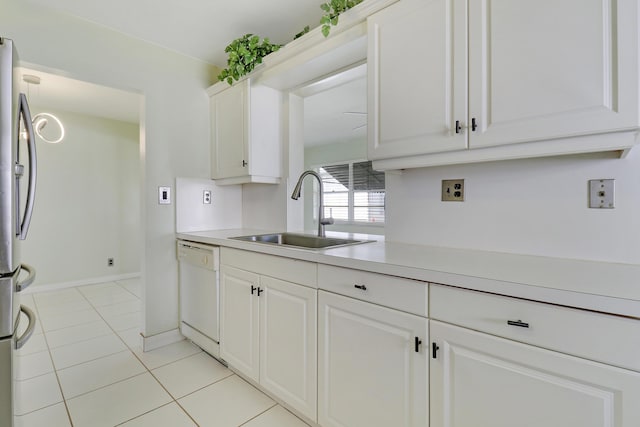 kitchen with dishwasher, sink, stainless steel fridge, light tile patterned flooring, and white cabinetry