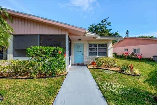 property entrance with a lawn