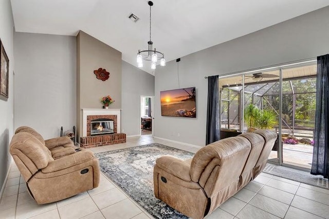 living room featuring light tile patterned flooring, a fireplace, high vaulted ceiling, and an inviting chandelier