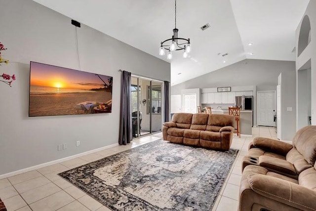 living room featuring a notable chandelier, light tile patterned flooring, and high vaulted ceiling