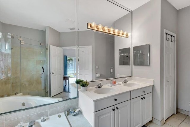 bathroom with tile patterned flooring, vanity, and independent shower and bath