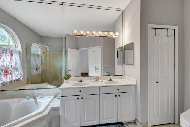 bathroom with shower with separate bathtub, vanity, and tile patterned floors