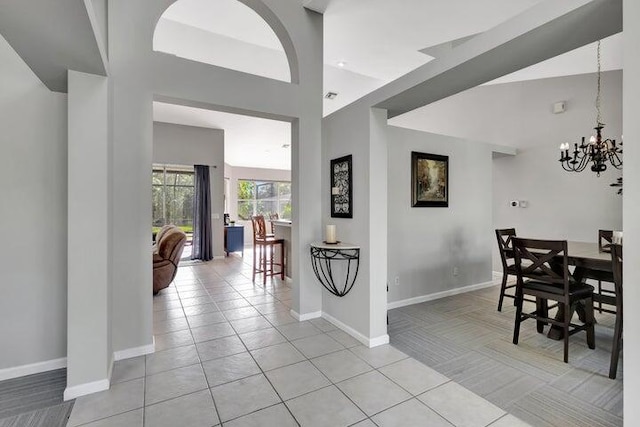 dining room featuring high vaulted ceiling, baseboards, a chandelier, and light tile patterned flooring