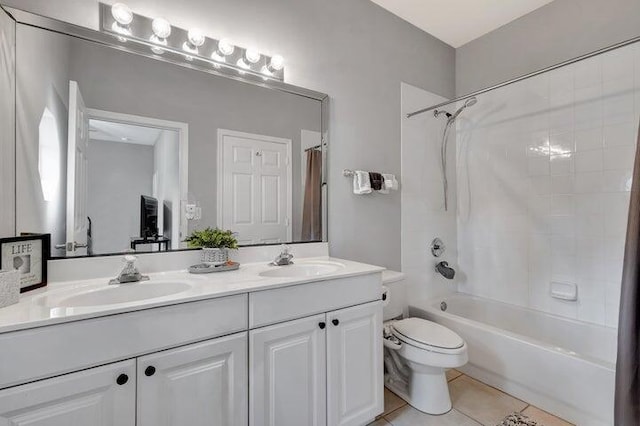 full bathroom featuring tile patterned flooring, vanity, toilet, and shower / bath combo with shower curtain