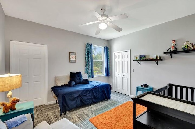 carpeted bedroom with ceiling fan and a closet