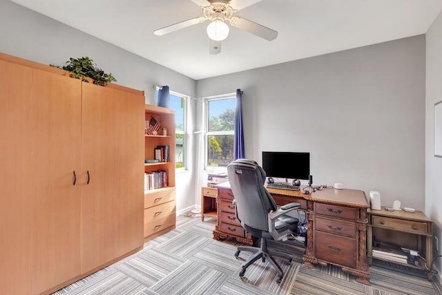 carpeted office featuring ceiling fan