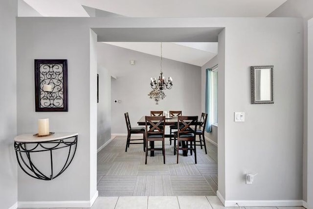 tiled dining room featuring vaulted ceiling and a notable chandelier