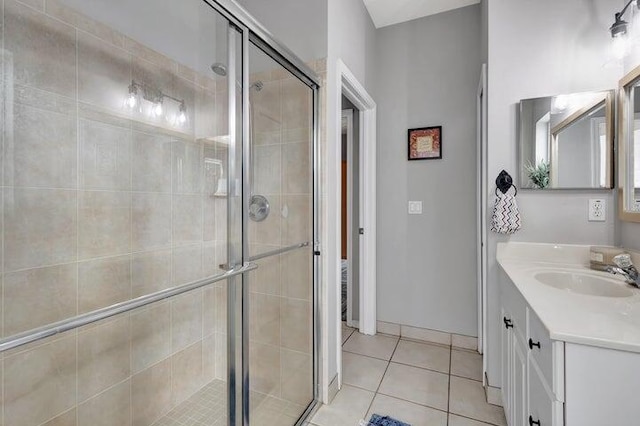 bathroom featuring tile patterned flooring, vanity, and an enclosed shower