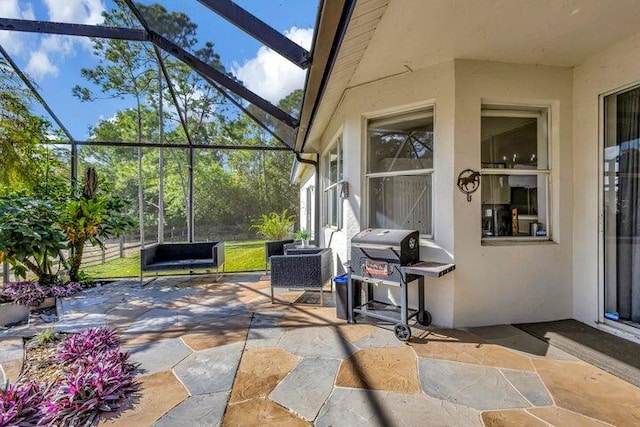 view of patio featuring area for grilling and a lanai