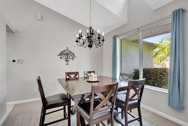 dining space with vaulted ceiling and an inviting chandelier