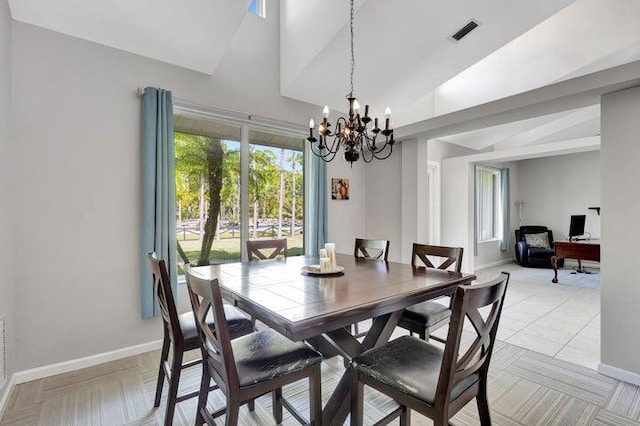 dining room with lofted ceiling and a notable chandelier