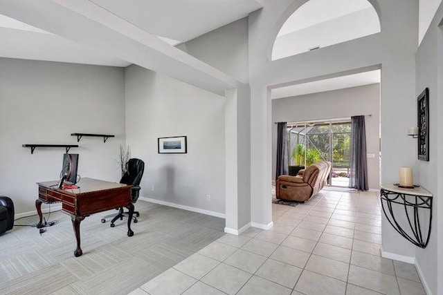 office area featuring light tile patterned floors and a high ceiling