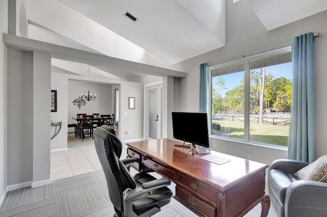 tiled office featuring a chandelier, a healthy amount of sunlight, and vaulted ceiling