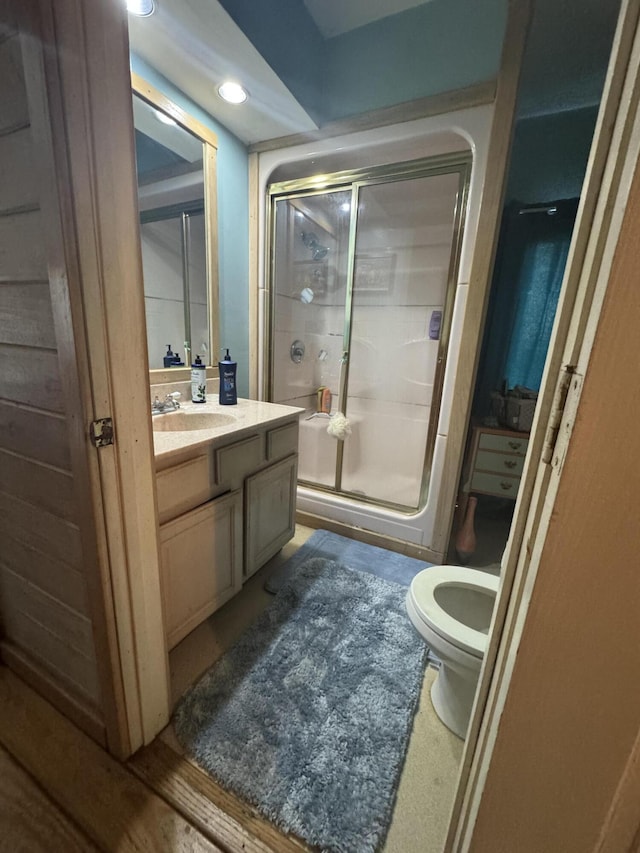 bathroom featuring vanity and an enclosed shower