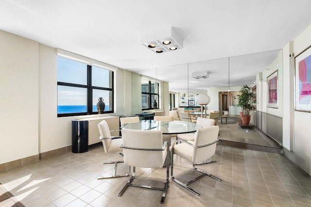 tiled dining space with a water view