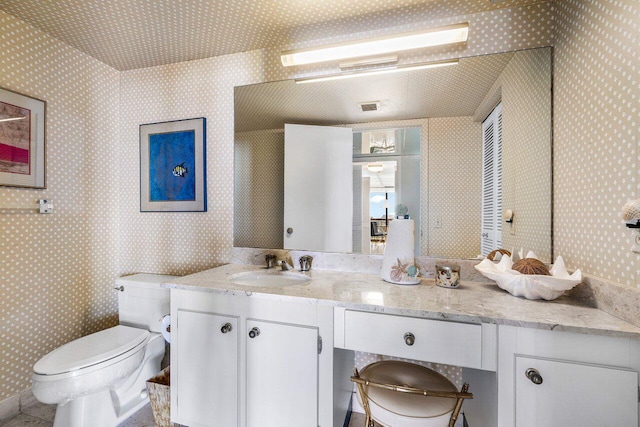 bathroom with vanity and toilet