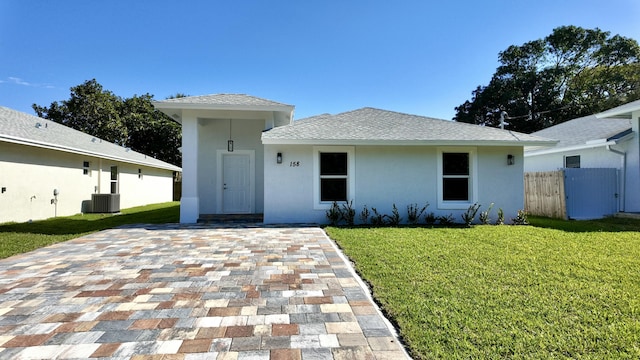 view of front of property with cooling unit and a front lawn