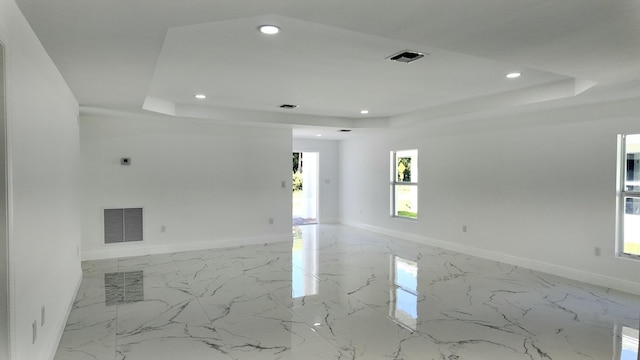 unfurnished room with a raised ceiling