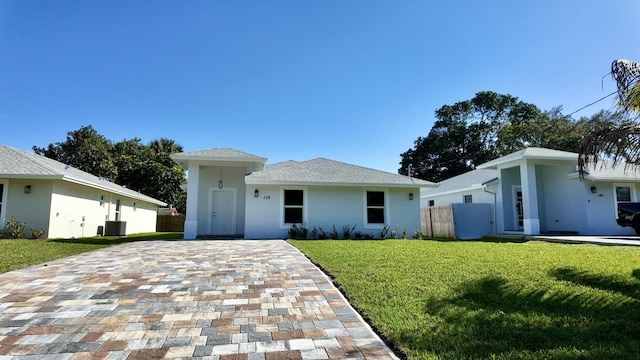 view of front of house featuring a front yard and central AC