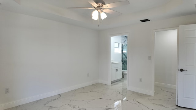 unfurnished bedroom with connected bathroom and ceiling fan