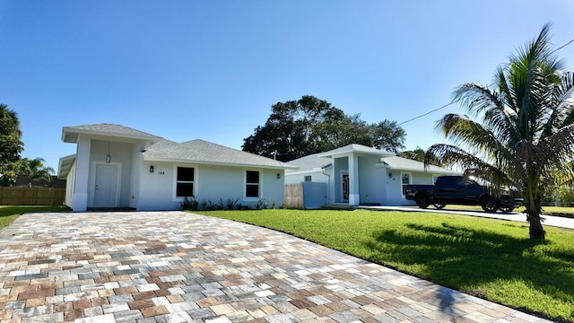 ranch-style house with a front lawn