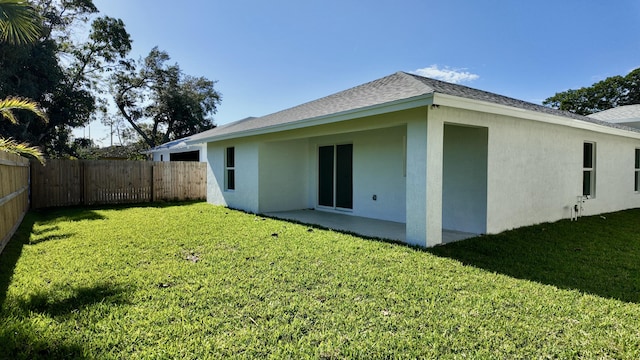 back of property featuring a yard