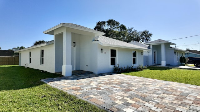 ranch-style home with a front lawn