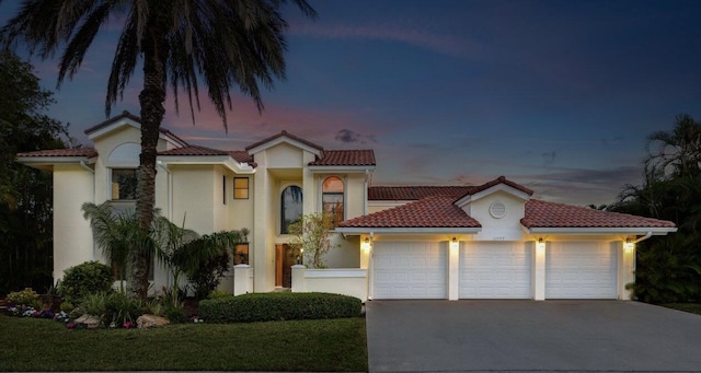 mediterranean / spanish-style house with a garage