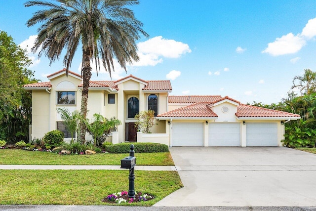 mediterranean / spanish-style home with a front lawn and a garage