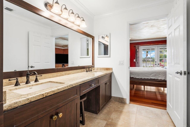 bathroom with tile patterned flooring, vanity, and crown molding