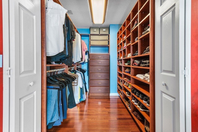 walk in closet featuring hardwood / wood-style flooring