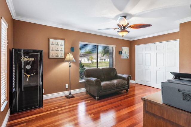 sitting room featuring crown molding, hardwood / wood-style floors, and ceiling fan