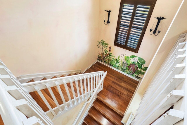 stairs featuring hardwood / wood-style flooring