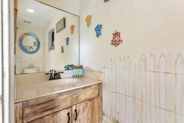 bathroom with vanity and toilet