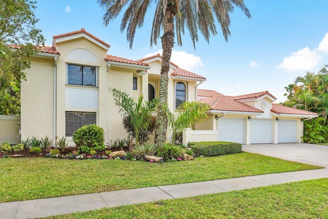 mediterranean / spanish home with a front lawn and a garage