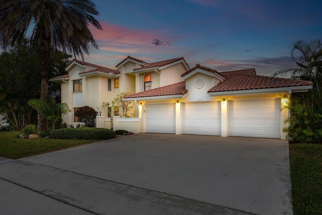 mediterranean / spanish house with a garage