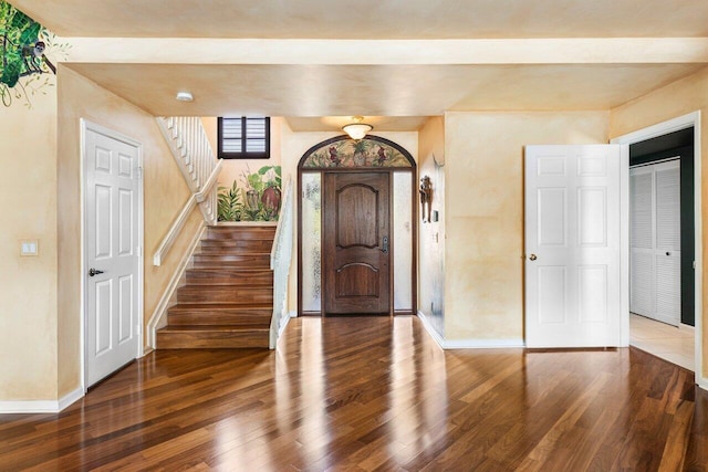 foyer entrance with dark hardwood / wood-style floors