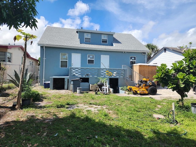 rear view of house featuring a lawn