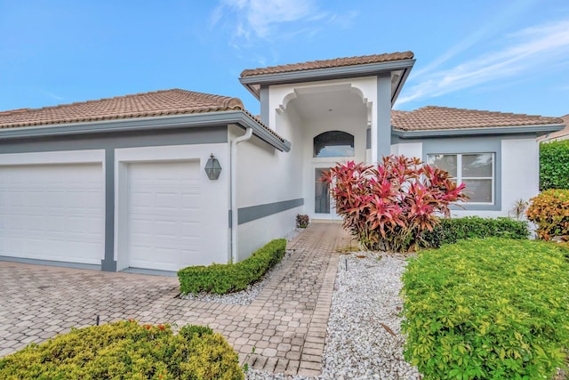 mediterranean / spanish-style home with a garage