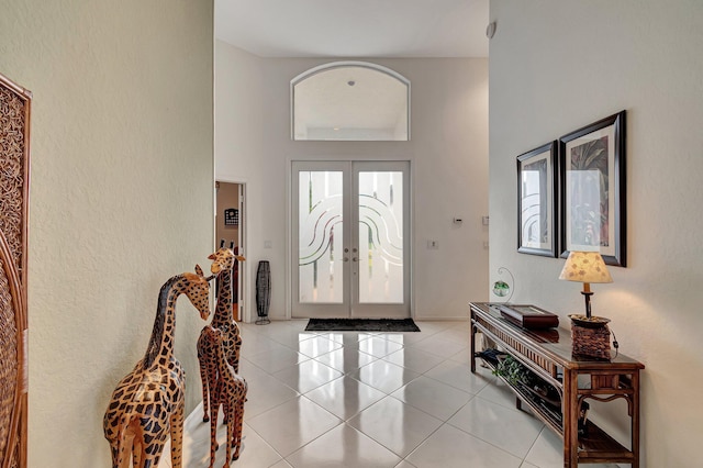 entryway with light tile patterned floors and french doors