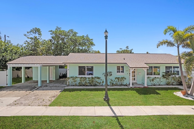 single story home featuring a front yard and a carport