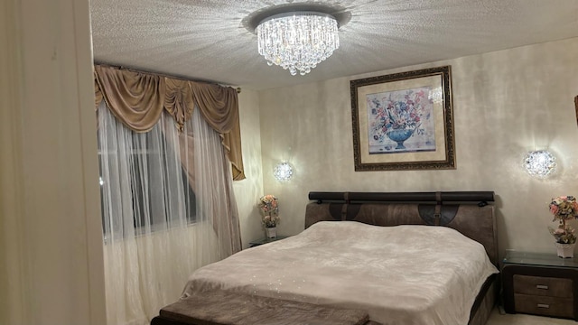 bedroom with a notable chandelier and a textured ceiling