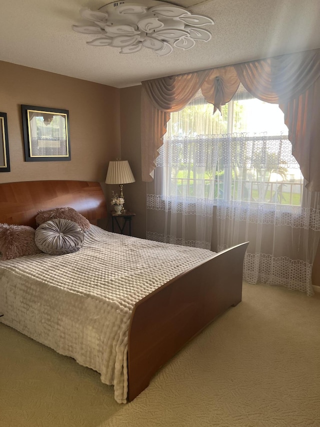 bedroom featuring a textured ceiling and carpet floors