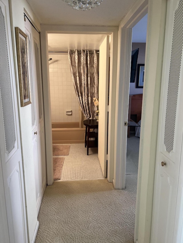 hall with a heating unit and carpet floors