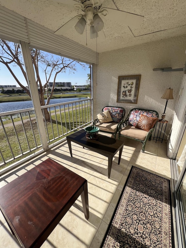sunroom / solarium with a ceiling fan, a water view, and outdoor lounge area