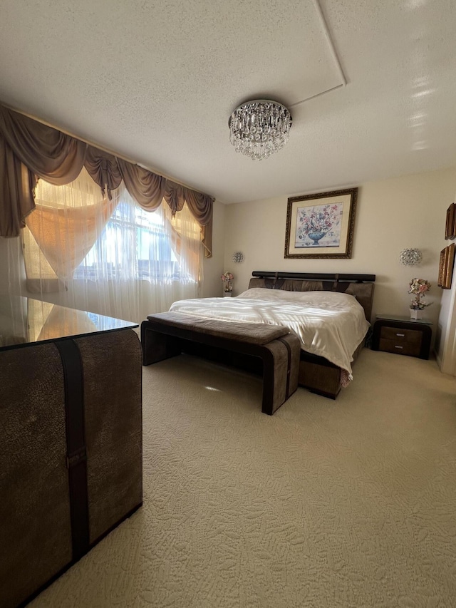 bedroom featuring carpet floors and a textured ceiling