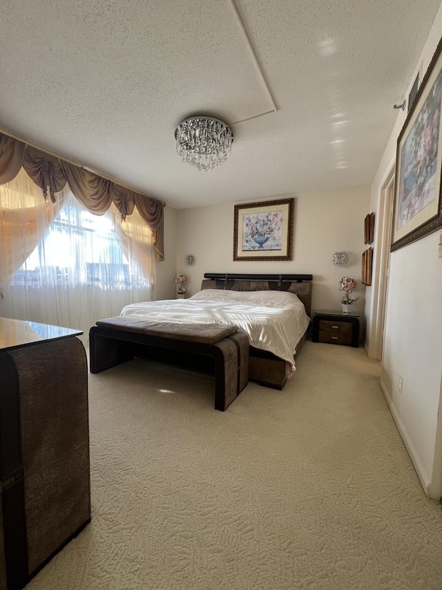 bedroom with a textured ceiling and carpet flooring